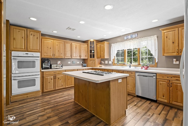 131 E Main St, Essex, IL 60935 - kitchen featuring white appliances, light countertops, dark wood-style flooring, a center island, and recessed lighting