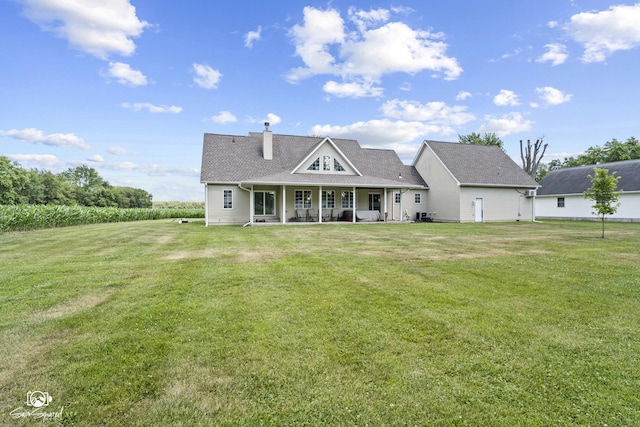 131 E Main St, Essex, IL 60935 - rear view of house with a yard, covered porch, and a chimney