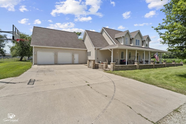 131 E Main St, Essex, IL 60935 - view of front of house featuring covered porch, a garage, concrete driveway, and a front yard