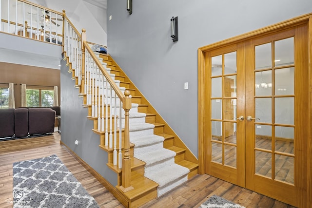 131 E Main St, Essex, IL 60935 - stairs with french doors, wood finished floors, and a towering ceiling