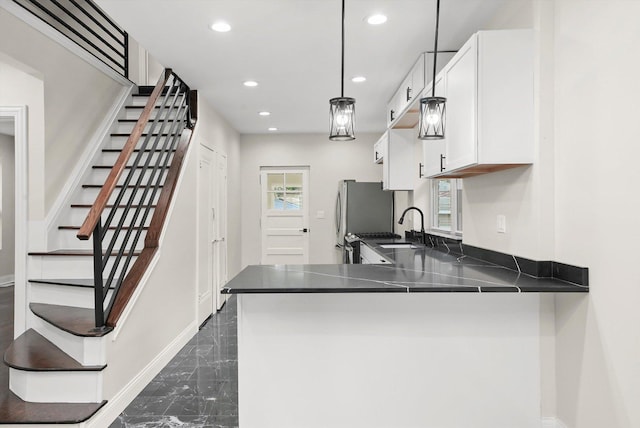 7711 S Honore St, Chicago, IL 60620 - kitchen with dark marble finish flooring, white cabinets, recessed lighting, dark countertops, and decorative light fixtures
