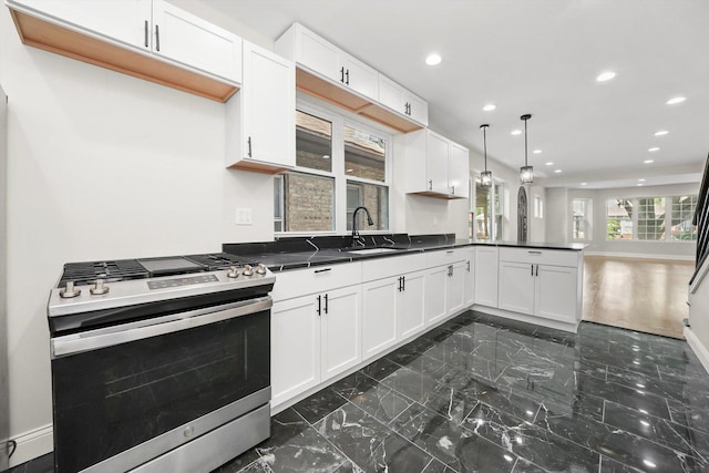 7711 S Honore St, Chicago, IL 60620 - kitchen with gas range, a peninsula, dark marble finish floors, dark countertops, and recessed lighting