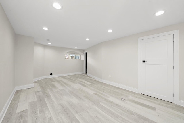 7711 S Honore St, Chicago, IL 60620 - basement featuring light wood-style flooring, recessed lighting, and arched walkways