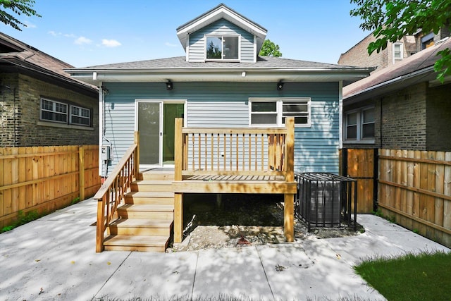 7711 S Honore St, Chicago, IL 60620 - rear view of house with a fenced backyard, a deck, and a shingled roof