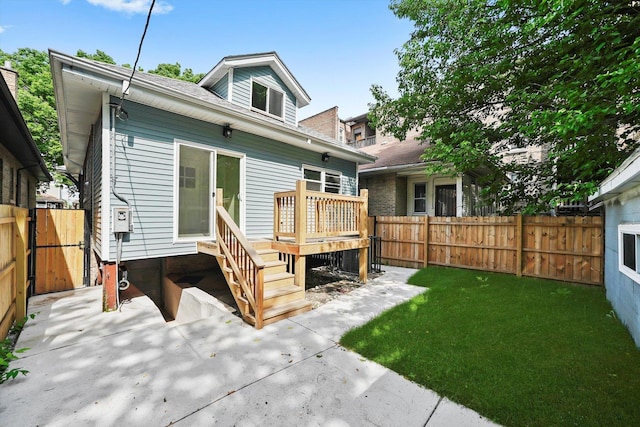 7711 S Honore St, Chicago, IL 60620 - back of house featuring a fenced backyard, a wooden deck, a patio, and a shingled roof