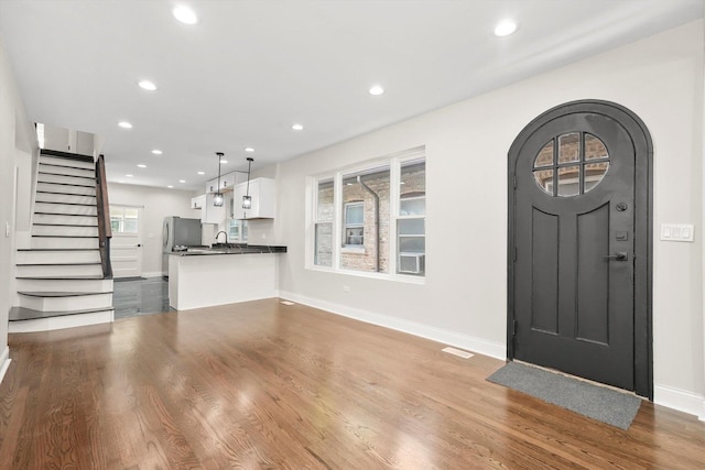 7711 S Honore St, Chicago, IL 60620 - entrance foyer with recessed lighting, stairs, and wood finished floors