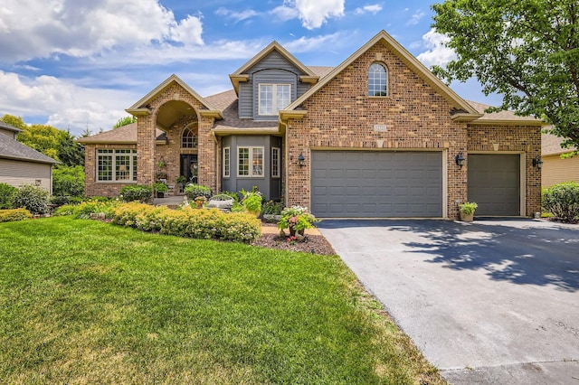 12723 Hawks Bill Ln, Plainfield, IL 60585 - traditional-style house featuring driveway, brick siding, a front lawn, roof with shingles, and an attached garage