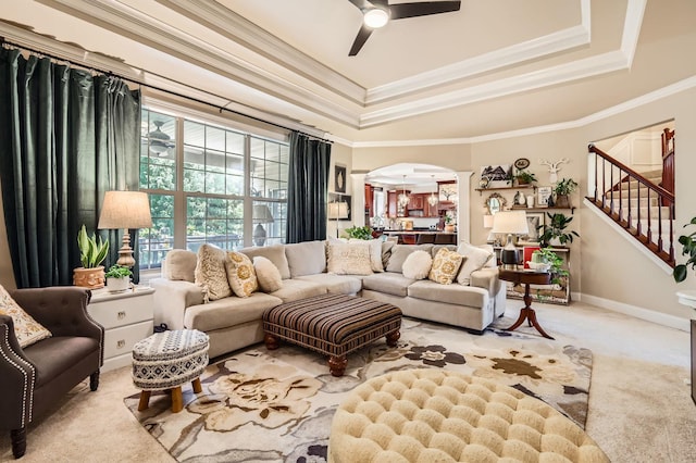 12723 Hawks Bill Ln, Plainfield, IL 60585 - living room with carpet floors, arched walkways, a ceiling fan, a tray ceiling, and decorative columns
