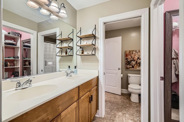 12723 Hawks Bill Ln, Plainfield, IL 60585 - bathroom featuring double vanity, a spacious closet, and tile patterned floors