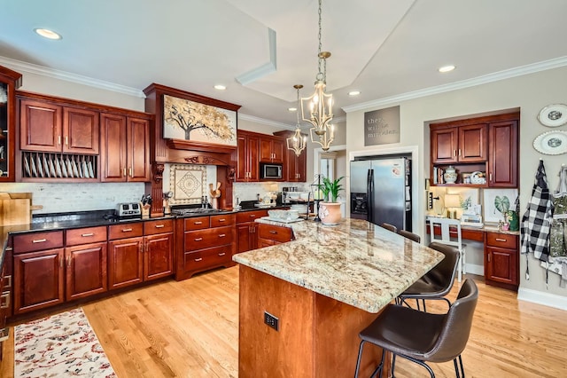 12723 Hawks Bill Ln, Plainfield, IL 60585 - kitchen with stainless steel appliances, ornamental molding, a center island with sink, open shelves, and light wood finished floors