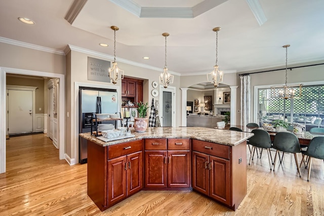 12723 Hawks Bill Ln, Plainfield, IL 60585 - kitchen with stainless steel refrigerator with ice dispenser, a chandelier, light wood-style flooring, crown molding, and pendant lighting