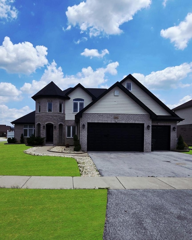 19811 Margaret Ct, Lynwood, IL 60411 - view of front of home with brick siding, a front lawn, a garage, and asphalt driveway