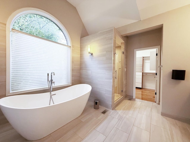 26159 N Hill Ave, Wauconda, IL 60084 - full bathroom with lofted ceiling, a stall shower, a freestanding bath, tile walls, and a spacious closet