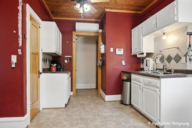 1100 N Hart St, Harvard, IL 60033 - kitchen featuring wood ceiling, dark countertops, ceiling fan, white cabinetry, and tasteful backsplash