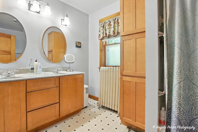 1100 N Hart St, Harvard, IL 60033 - full bathroom with radiator, double vanity, and tile patterned floors
