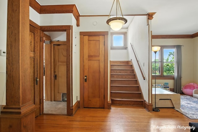 1100 N Hart St, Harvard, IL 60033 - stairs with healthy amount of natural light, wood finished floors, and crown molding