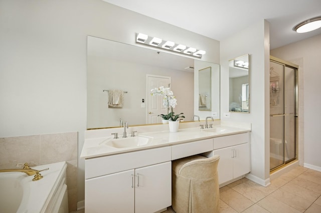 451 Town Place Cir Unit 308, Buffalo Grove, IL 60089 - bathroom featuring double vanity, a shower stall, a garden tub, and tile patterned flooring