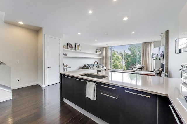 1028 N Hermitage Ave Unit 3, Chicago, IL 60622 - kitchen with dark cabinets, recessed lighting, dark wood-type flooring, and light countertops
