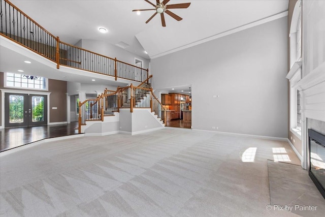 2814 Hapner Way, Batavia, IL 60510 - unfurnished living room with a towering ceiling, carpet flooring, stairs, a premium fireplace, and a ceiling fan