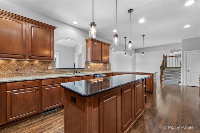 2814 Hapner Way, Batavia, IL 60510 - kitchen featuring a kitchen island, decorative backsplash, dark wood-style floors, arched walkways, and recessed lighting
