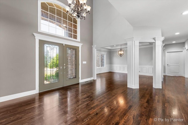2814 Hapner Way, Batavia, IL 60510 - foyer featuring a chandelier, ornate columns, wood finished floors, a towering ceiling, and wainscoting