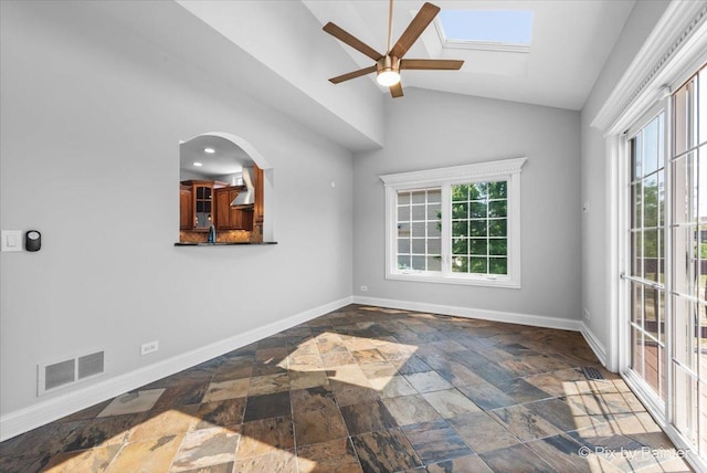2814 Hapner Way, Batavia, IL 60510 - spare room featuring stone tile floors, a ceiling fan, lofted ceiling, and a skylight