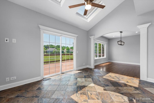 2814 Hapner Way, Batavia, IL 60510 - unfurnished room featuring decorative columns, stone tile flooring, ceiling fan, arched walkways, and high vaulted ceiling