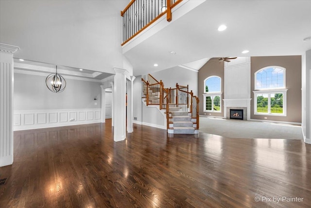 2814 Hapner Way, Batavia, IL 60510 - unfurnished living room featuring high vaulted ceiling, ceiling fan, decorative columns, stairs, and a fireplace