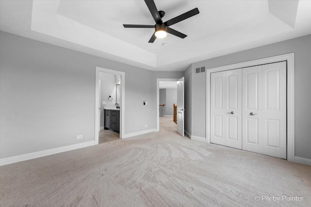 2814 Hapner Way, Batavia, IL 60510 - unfurnished bedroom featuring a raised ceiling, light carpet, a closet, ensuite bathroom, and ceiling fan