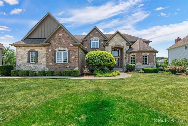 2814 Hapner Way, Batavia, IL 60510 - view of front of house with board and batten siding, a front lawn, stone siding, and brick siding