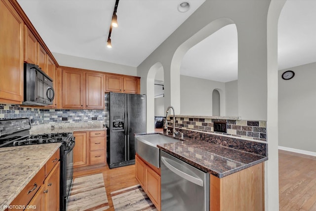 1697 Deer Pointe Dr, South Elgin, IL 60177 - kitchen with black appliances, light wood-style floors, tasteful backsplash, and dark stone counters