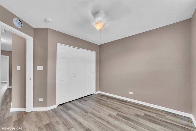1697 Deer Pointe Dr, South Elgin, IL 60177 - unfurnished bedroom featuring light wood-style flooring, a closet, and a ceiling fan