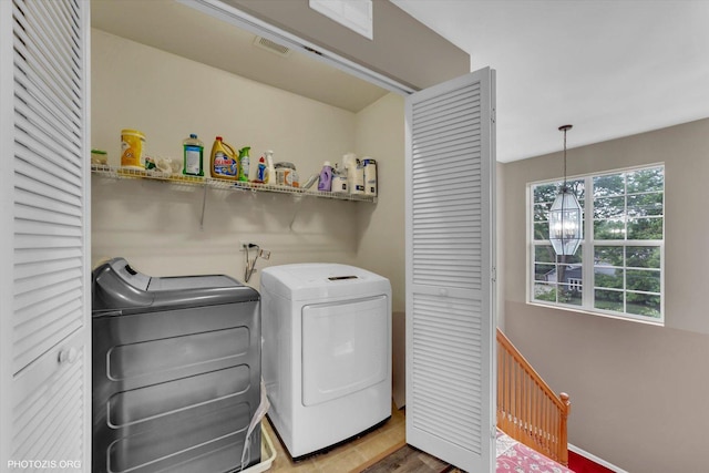 1697 Deer Pointe Dr, South Elgin, IL 60177 - laundry area featuring independent washer and dryer and wood finished floors