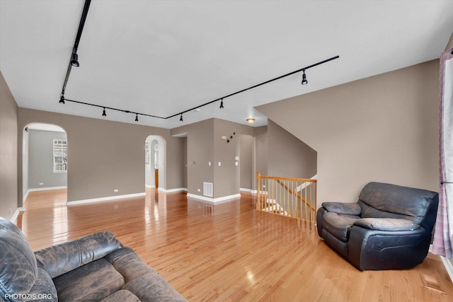 1697 Deer Pointe Dr, South Elgin, IL 60177 - living area with rail lighting, arched walkways, and light wood-type flooring