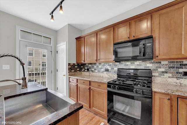 1697 Deer Pointe Dr, South Elgin, IL 60177 - kitchen featuring black appliances, tasteful backsplash, and brown cabinetry