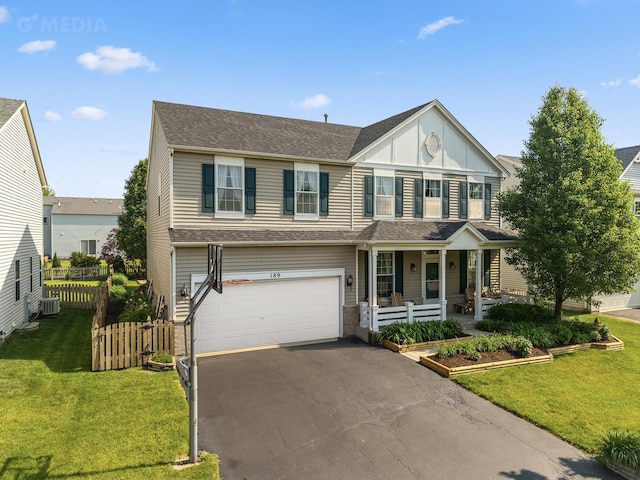 189 E Lark Ave, Cortland, IL 60112 - view of front facade featuring a porch, a garage, asphalt driveway, board and batten siding, and a shingled roof