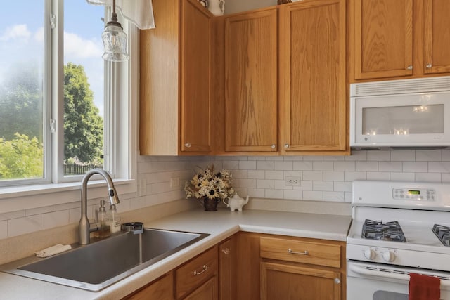 189 E Lark Ave, Cortland, IL 60112 - kitchen with white appliances, decorative backsplash, light countertops, and brown cabinetry