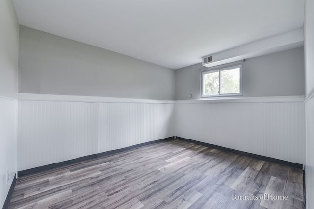 450 E Briarcliff Rd, Bolingbrook, IL 60440 - spare room featuring a wainscoted wall and wood finished floors