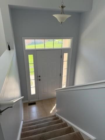 56 Veneto Ct, Streamwood, IL 60107 - entryway with healthy amount of natural light, stairs, and tile patterned flooring