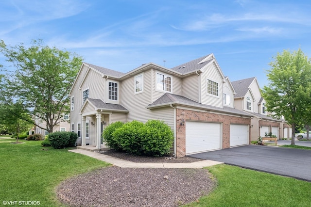 17660 S Gilbert Dr, Lockport, IL 60441 - view of front facade featuring an attached garage, driveway, a front yard, and brick siding