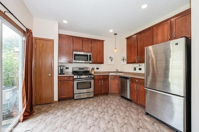 17660 S Gilbert Dr, Lockport, IL 60441 - kitchen with appliances with stainless steel finishes, brown cabinetry, light countertops, decorative light fixtures, and recessed lighting