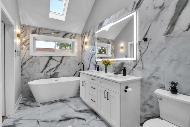 7635 W Balmoral Ave, Chicago, IL 60656 - full bath featuring tile walls, a skylight, double vanity, a freestanding bath, and marble tiled floors