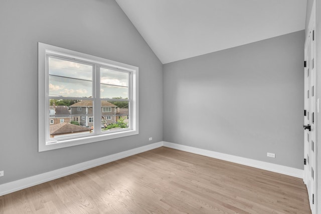 7635 W Balmoral Ave, Chicago, IL 60656 - unfurnished room with vaulted ceiling and light wood-type flooring