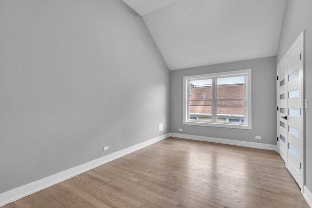 7635 W Balmoral Ave, Chicago, IL 60656 - empty room featuring vaulted ceiling and light wood-style flooring