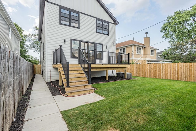 7635 W Balmoral Ave, Chicago, IL 60656 - rear view of house with a fenced backyard, stairs, a deck, and board and batten siding