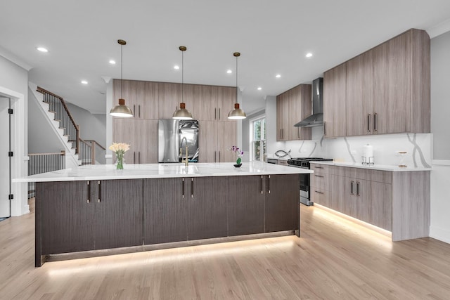 7635 W Balmoral Ave, Chicago, IL 60656 - kitchen featuring gas stove, wall chimney range hood, modern cabinets, fridge, and light wood-style flooring