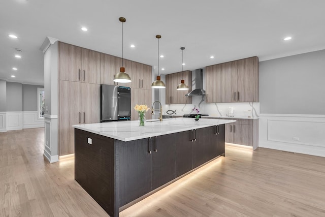 7635 W Balmoral Ave, Chicago, IL 60656 - kitchen with modern cabinets, wall chimney range hood, fridge, a decorative wall, and a large island with sink
