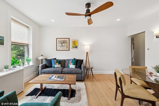 1219 W Lunt Ave Unit 1B, Chicago, IL 60626 - living room with radiator heating unit, a ceiling fan, light wood-style flooring, and recessed lighting