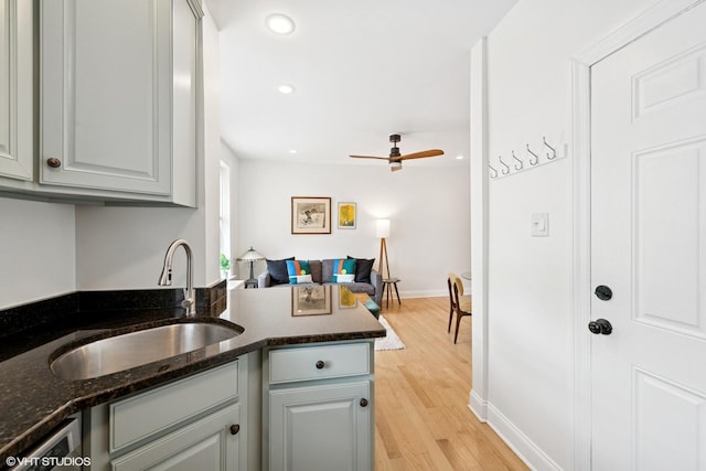 1219 W Lunt Ave Unit 1B, Chicago, IL 60626 - kitchen with light wood-style floors, open floor plan, dark stone countertops, ceiling fan, and recessed lighting