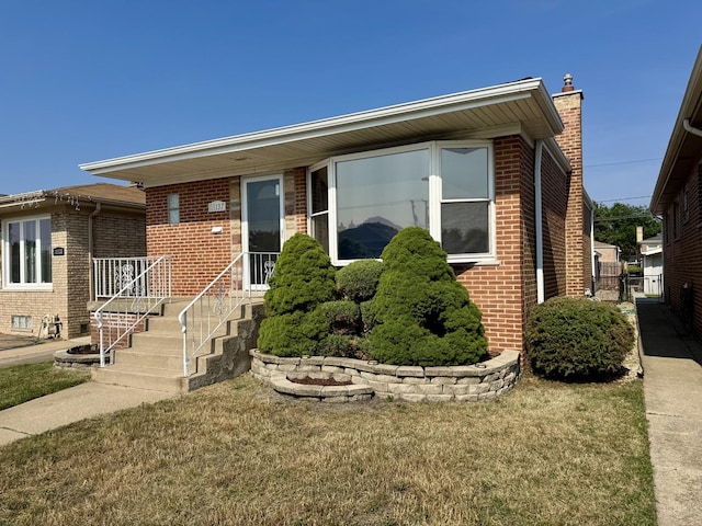 11137 S S Ave L, Chicago, IL 60617 - view of front facade with brick siding and a front lawn